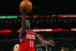 NEW ORLEANS, LA - JANUARY 04:  Jrue Holiday #11 of the Philadelphia 76ers makes a shot over Trey Johnson #12 of the New Orleans Hornets at New Orleans Arena on January 4, 2012 in New Orleans, Louisiana.  NOTE TO USER: User expressly acknowledges and agrees that, by downloading and or using this photograph, User is consenting to the terms and conditions of the Getty Images License Agreement.  (Photo by Chris Graythen/Getty Images)
