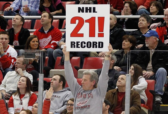 DETROIT, MI - FEBRUARY 14: A fan holds up a sign congratulating the Detroit Red Wings on their NHL record breaking 21st consecutive home victory by beating the Dallas Stars 3-1 at Joe Louis Arena on February 14, 2012 in Detroit, Michigan. (Photo by Gregory Shamus/Getty Images)