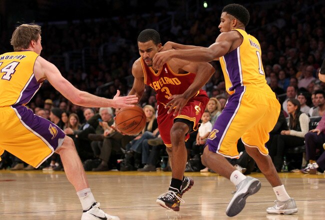 LOS ANGELES, CA - JANUARY 13: Ramon Sessions #3 of the Cleveland Cavaliers drives between Darius Morris #1 and Troy Murphy #14 of the Los Angeles Lakers at Staples Center on January 13, 2012 in Los Angeles, California.  The Lakers won 97-92. NOTE TO USER: User expressly acknowledges and agrees that, by downloading and or using this photograph, User is consenting to the terms and conditions of the Getty Images License Agreement.  (Photo by Stephen Dunn/Getty Images)