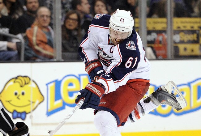 LOS ANGELES, CA - JANUARY 07:  Rick Nash #61 of the Columbus Blue Jackets takes a shot in front of Willie Mitchell #33 of the Los Angeles Kings at Staples Center on January 7, 2012 in Los Angeles, California.  (Photo by Harry How/Getty Images)