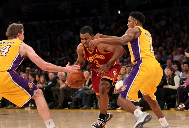 LOS ANGELES, CA - JANUARY 13: Ramon Sessions #3 of the Cleveland Cavaliers drives between Darius Morris #1 and Troy Murphy #14 of the Los Angeles Lakers at Staples Center on January 13, 2012 in Los Angeles, California.  The Lakers won 97-92. NOTE TO USER: User expressly acknowledges and agrees that, by downloading and or using this photograph, User is consenting to the terms and conditions of the Getty Images License Agreement.  (Photo by Stephen Dunn/Getty Images)