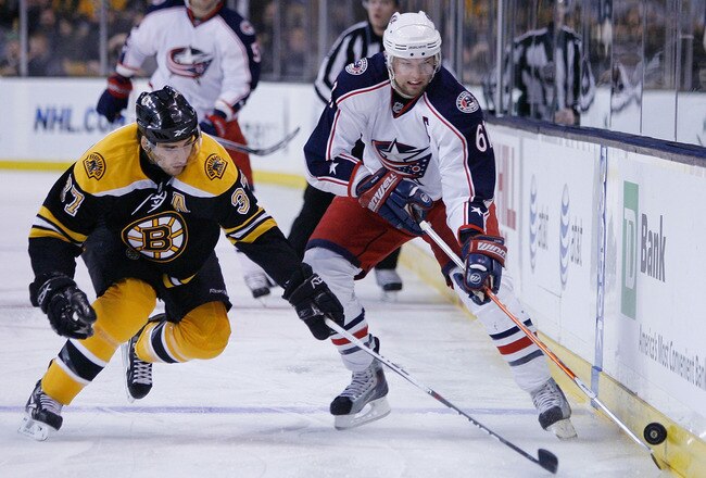 BOSTON - JANUARY 21:  Rick Nash #61 of the Columbus Blue Jackets tries the keep the puck from Patrice Bergeron #37 of the Boston Bruins on January 21, 2010 at the TD Garden in Boston, Massachusetts.  (Photo by Elsa/Getty Images)