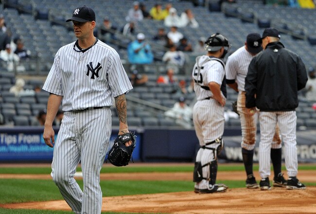NEW YORK, NY - SEPTEMBER 07: A.J. Burnett #34 of the New York Yankees walks back to the dugout after being taken out of the game in the top of the seventh inning against the Baltimore Orioles and New York Yankees on September 7, 2011 at Yankee Stadium in the Bronx borough of New York City. (Photo by Christopher Pasatieri/Getty Images)