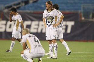 FOXBORO, MA - JULY 14:  Leandro Augusto #7 and Dario Veron #4 of Pumas UNAM react after a loss against the New England Revolution at Gillette Stadium on July 14, 2010 in Foxboro, Massachusetts. The Revolution defeated Puma UNAM 1-0.  (Photo by Elsa/Getty Images)