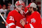DETROIT, MI - FEBRUARY 08:  Joey MacDonald #31 of the Detroit Red Wings is congratulated by Ty Conklin #29 after a 4-2 win over the Edmonton Oilers at Joe Louis Arena on February 8, 2012 in Detroit, Michigan. (Photo by Gregory Shamus/Getty Images)