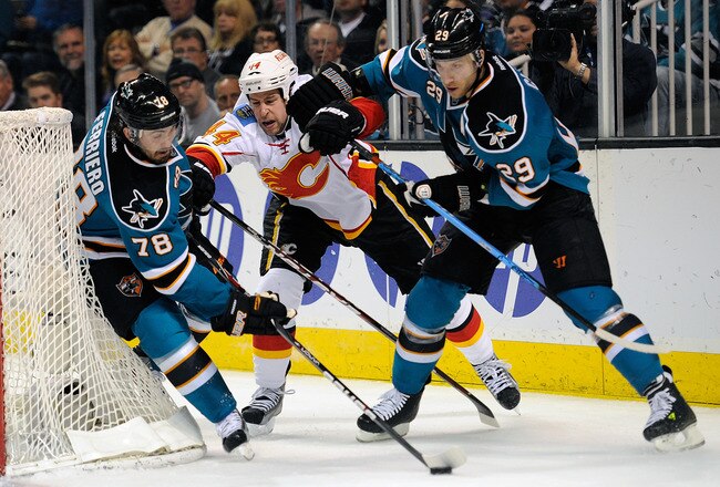 SAN JOSE, CA - FEBRUARY 08:  Benn Ferriero #78 of the San Jose Sharks takes control of the puck away from teammate Ryane Clowe #29 and Chris Butler #44 of the Calgary Flames at HP Pavilion at San Jose on February 8, 2012 in San Jose, California.  (Photo by Thearon W. Henderson/Getty Images)
