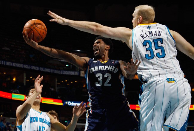 NEW ORLEANS, LA - JANUARY 18:  O.J. Mayo #32 of the Memphis Grizzlies shoots the ball around Chris Kaman #35 of the New Orleans Hornets at New Orleans Arena on January 18, 2012 in New Orleans, Louisiana.  NOTE TO USER: User expressly acknowledges and agrees that, by downloading and or using this photograph, User is consenting to the terms and conditions of the Getty Images License Agreement.  (Photo by Chris Graythen/Getty Images)