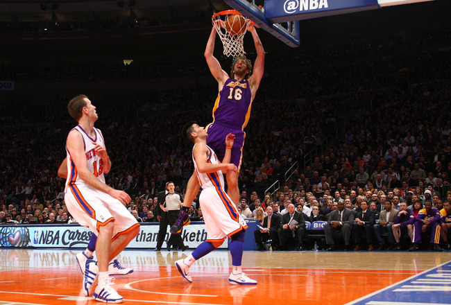NEW YORK, NY - FEBRUARY 10:  Pau Gasol #16 of the Los Angeles Lakers dunks in the second quarter against Jeremy Lin #17 of the New York Knicks at Madison Square Garden on February 10, 2012 in New York City.  NOTE TO USER: User expressly acknowledges and agrees that, by downloading and or using this photograph, User is consenting to the terms and conditions of the Getty Images License Agreement.  (Photo by Chris Chambers/Getty Images)