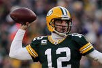 GREEN BAY, WI - JANUARY 15:   Aaron Rodgers #12 of the Green Bay Packers drops back to pass against the New York Giants during their NFC Divisional playoff game at Lambeau Field on January 15, 2012 in Green Bay, Wisconsin.  (Photo by Jonathan Daniel/Getty Images)