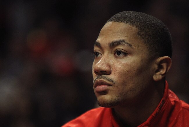 CHICAGO, IL - FEBRUARY 14:  Derrick Rose #1 of the Chicago Bulls, held out of the game with a sore back, watches his teammates take on the Sacramento Kings at the United Center on February 14, 2012 in Chicago, Illinois. The Bulls defeated the Kings 121-115. NOTE TO USER: User expressly acknowledges and agrees that, by downloading and or using this photograph, User is consenting to the terms and conditions of the Getty Images License Agreement.  (Photo by Jonathan Daniel/Getty Images)