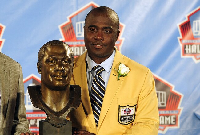 CANTON, OH - AUGUST 6:  Former St. Louis Rams running back Marshal Faulk (R) and his agent Rocky Arceneaux pose with Faulk's bust at the Enshrinement Ceremony for the Pro Football Hall of Fame on August 6, 2011 in Canton, Ohio.  (Photo by Jason Miller/Getty Images)