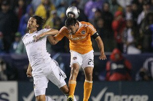 CARSON, CA - NOVEMBER 20:  Omar Gonzalez #4 of the Los Angeles Galaxy and Brian Ching #25 of the Houston Dynamo vie for a high ball during the 2011 MLS Cup at The Home Depot Center on November 20, 2011 in Carson, California.  (Photo by Stephen Dunn/Getty Images)