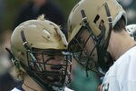 Notre Dame's Matt Karweck, left, is congratulated by a teammate after scoring a goal against Syracuse at Harvard University's Jordan Field during The Algonquin Cup College Lacrosse Invitational Tournament Saturday, October 18, 2003. (Photo by J Rogash/Getty Images)