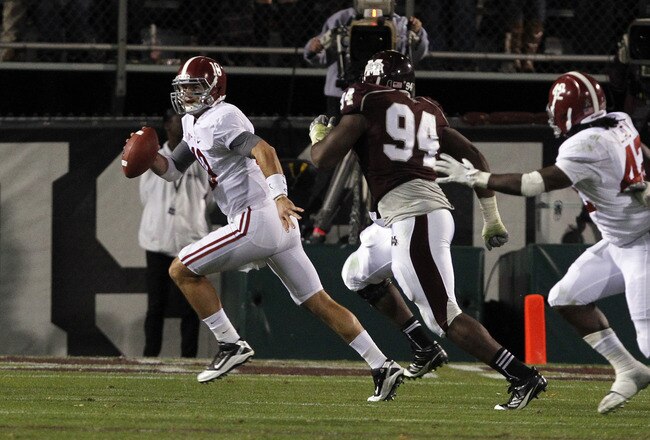 STARKVILLE, MS - NOVEMBER 12:  quarterback AJ McCarron #10 of the Alabama Crimson Tide scrambles away from pressure from defensive lineman Fletcher Cox #94 of the Mississippi State Bulldogs on November 12, 2011 at Davis Wade Stadium in Starkville, Mississippi. Alabama won 24-7. (Photo by Butch Dill/Getty Images)