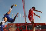 MUSCAT, OMAN - DECEMBER 11:  Seksan Tubtong of Thailand kicks the takraw over the net as Ali Hassan Ali Al Hinai of Oman defends in the Beach Sepaktakraw Semi-final between Thailand and Oman at Al-Musannah Sports City during day four of the 2nd Asian Beach Games Muscat 2010 on December 11, 2010 in Muscat, Oman.  (Photo by Cameron Spencer/Getty Images)