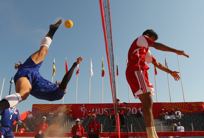MUSCAT, OMAN - DECEMBER 11:  Seksan Tubtong of Thailand kicks the takraw over the net as Ali Hassan Ali Al Hinai of Oman defends in the Beach Sepaktakraw Semi-final between Thailand and Oman at Al-Musannah Sports City during day four of the 2nd Asian Beach Games Muscat 2010 on December 11, 2010 in Muscat, Oman.  (Photo by Cameron Spencer/Getty Images)