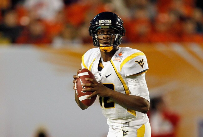 MIAMI GARDENS, FL - JANUARY 04:  Geno Smith #12 of the West Virginia Mountaineers looks to pass against the Clemson Tigers during the Discover Orange Bowl at Sun Life Stadium on January 4, 2012 in Miami Gardens, Florida.  (Photo by Streeter Lecka/Getty Images)