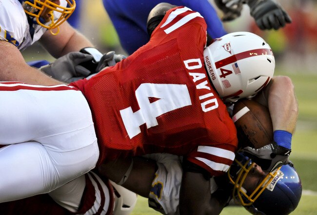 LINCOLN, NEBRASKA - SEPTEMBER 25: Nebraska Cornhuskers linebacker Lavonte David #4 tackles South Dakota State Jackrabbits running back Kyle Minett #30 during first half action of their game at Memorial Stadium on September 25, 2010 in Lincoln, Nebraska. Nebraska Defeated South Dakota State 17-3. (Photo by Eric Francis/Getty Images)