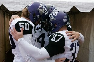 BOISE, ID - NOVEMBER 12:  Daniel Shelley #50, Anson Kelton #4, and Ross Evans #37 of the TCU Horned Frogs psyche up before the game against the Boise State Broncos at Bronco Stadium on November 12, 2011 in Boise, Idaho.  (Photo by Otto Kitsinger III/Getty Images)