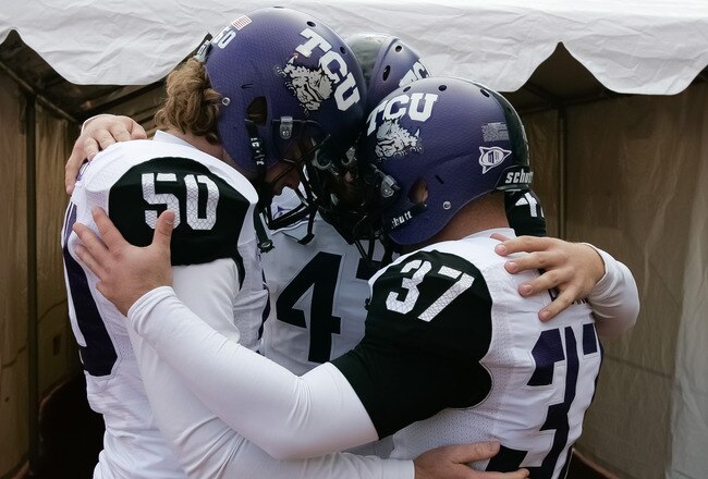 BOISE, ID - NOVEMBER 12:  Daniel Shelley #50, Anson Kelton #4, and Ross Evans #37 of the TCU Horned Frogs psyche up before the game against the Boise State Broncos at Bronco Stadium on November 12, 2011 in Boise, Idaho.  (Photo by Otto Kitsinger III/Getty Images)