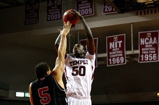 PHILADELPHIA, PA - DECEMBER 18:  Micheal Eric #50 of the Temple Owls attempts a shot against Tim Toler #5 of the Northern Illinois Huskies at the Liacouras Center on December 18, 2010 in Philadelphia, Pennsylvania.  (Photo by Chris Chambers/Getty Images)