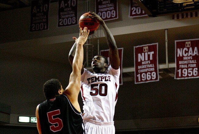 PHILADELPHIA, PA - DECEMBER 18:  Micheal Eric #50 of the Temple Owls attempts a shot against Tim Toler #5 of the Northern Illinois Huskies at the Liacouras Center on December 18, 2010 in Philadelphia, Pennsylvania.  (Photo by Chris Chambers/Getty Images)