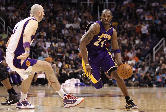 PHOENIX, AZ - JANUARY 05:  Kobe Bryant #24 of the Los Angeles Lakers handles the ball during the NBA game against the Phoenix Suns at US Airways Center on December 23, 2011 in Phoenix, Arizona. The Lakers defeated the Suns 99-95.  NOTE TO USER: User expressly acknowledges and agrees that, by downloading and or using this photograph, User is consenting to the terms and conditions of the Getty Images License Agreement.  (Photo by Christian Petersen/Getty Images)