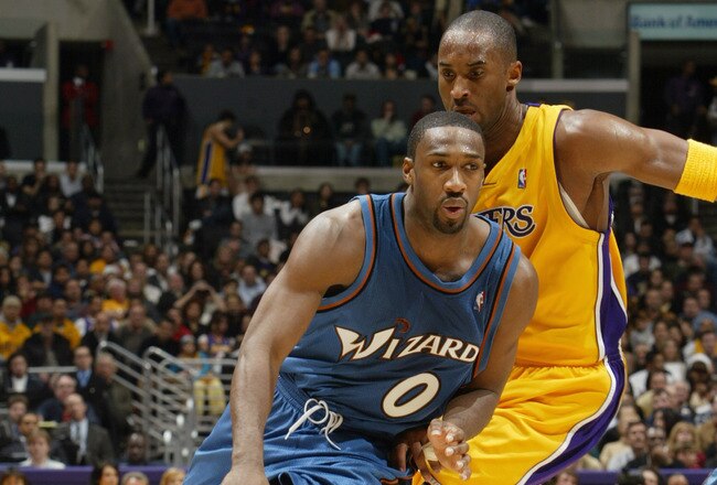 LOS ANGELES - DECEMBER 16:  Gilbert Arenas #0 of the Washington Wizards drives past Kobe Bryant #8 of the Los Angeles Lakers during a game at Staples Center on December 16, 2005 in Los Angeles, California.  The Lakers won 97-91.  NOTE TO USER:  User expressly acknowledges and agrees that, by downloading and/or using this Photograph, user is consenting to the terms and conditions of the Getty Images License Agreement. (Photo by Stephen Dunn/Getty Images)