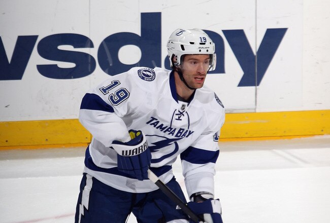 UNIONDALE, NY - DECEMBER 06:  Dominic Moore #19 of the Tampa Bay Lightning skates against the New York Islanders at the Nassau Veterans Memorial Coliseum on December 6, 2011 in Uniondale, New York. The Islanders defeated the Lightning 5-1.  (Photo by Bruce Bennett/Getty Images)