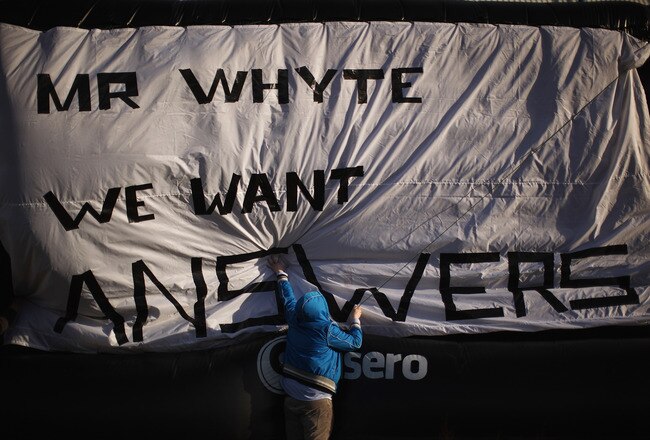 GLASGOW, SCOTLAND - FEBRUARY 15:  Rangers fan Michael Haggerty displays a banner outside directed to club owner Craig Whyte, outside the Ibrox Stadium on February 15, 2012 in Glasgow, Scotland. The Clydesdale Bank Premier League club entered administration yesterday over an unpaid tax bill of 9 million GBP.  (Photo by Jeff J Mitchell/Getty Images)