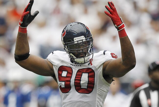 HOUSTON - SEPTEMBER 11:  Mario Williams #90 of the Houston Texans gets the crowd hyped up during a football game between the Indianapolis Colts and the Houston Texans at Reliant Stadium on September 11, 2011 in Houston, Texas.  (Photo by Bob Levey/Getty Images)