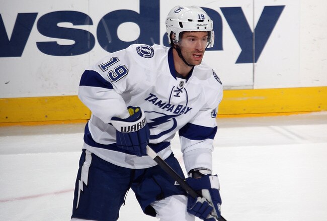 UNIONDALE, NY - DECEMBER 06:  Dominic Moore #19 of the Tampa Bay Lightning skates against the New York Islanders at the Nassau Veterans Memorial Coliseum on December 6, 2011 in Uniondale, New York. The Islanders defeated the Lightning 5-1.  (Photo by Bruce Bennett/Getty Images)