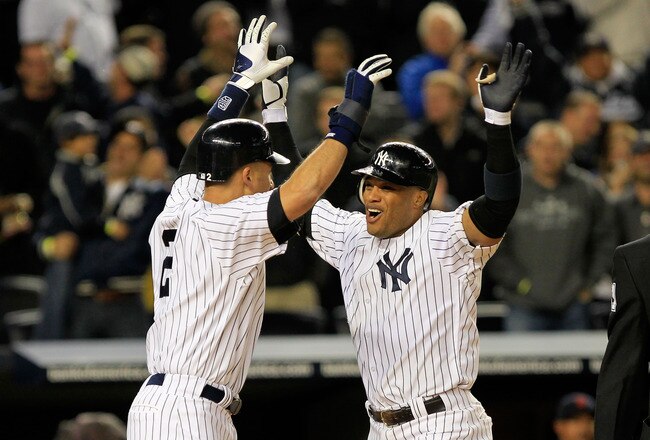NEW YORK, NY - OCTOBER 01:  Robinson Cano #24 of the New York Yankees is congratulated by Derek Jeter #2 after hitting a grand slam home run in the sixth inning of Game One of the American League Division Series against the Detroit Tigers at Yankee Stadium on October 1, 2011 in New York City.  (Photo by Chris Trotman/Getty Images)