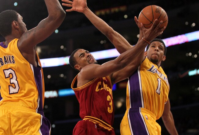 LOS ANGELES, CA - JANUARY 13:  Ramon Sessions #3 of the Cleveland Cavaliers goes up for a shot between Darius Morris #1 and Devin Ebanks #3 of the Los Angeles Lakers at Staples Center on January 13, 2012 in Los Angeles, California.  The Lakers won 97-92.  NOTE TO USER: User expressly acknowledges and agrees that, by downloading and or using this photograph, User is consenting to the terms and conditions of the Getty Images License Agreement.  (Photo by Stephen Dunn/Getty Images)