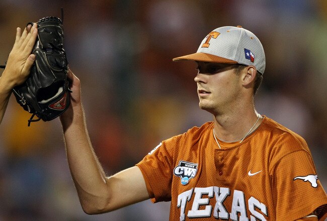 OMAHA, NE - JUNE 23:  Taylor Jungmann #26 of the Texas Longhorns is congratulated after another scoreless inning against the Louisiana State University Tigers during Game 2 of the 2009 NCAA College World Series at Rosenblatt Stadium on June 23, 2009 in Omaha, Nebraska. The Longhorns defeated the Tigers 5-1. Jungmann pitched a complete game.  (Photo by Elsa/Getty Images)