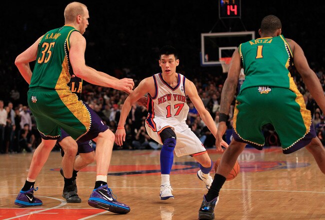 NEW YORK, NY - FEBRUARY 17:  (C) Jeremy Lin #17 of the New York Knicks drives against (L) Chris Kaman #35 of the New Orleans Hornets and (R) Trevor Ariza #1 of the New Orleans Hornets at Madison Square Garden on February 17, 2012 in New York City. NOTE TO USER: User expressly acknowledges and agrees that, by downloading and/or using this Photograph, user is consenting to the terms and conditions of the Getty Images License Agreement.  (Photo by Chris Trotman/Getty Images)