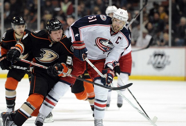 ANAHEIM, CA - FEBRUARY 03:  Rick Nash #61 of the Columbus Blue Jackets fends off Matt Beleskey #39 of the Anaheim Ducks as he carries the puck during the second period at Honda Center on February 3, 2012 in Anaheim, California.  (Photo by Harry How/Getty Images)
