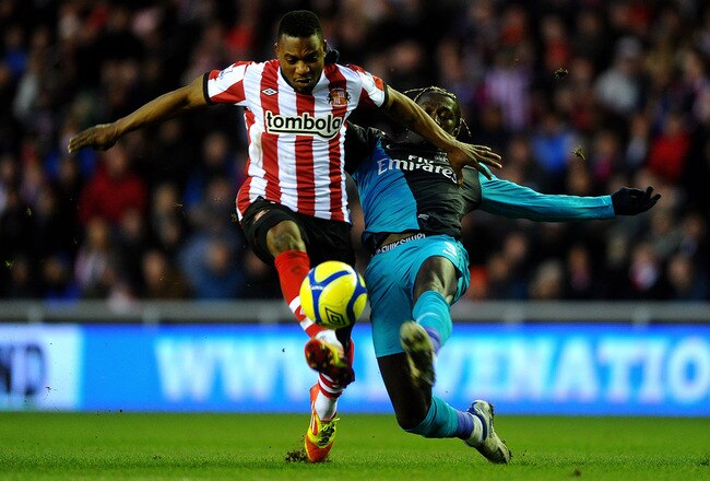 SUNDERLAND, ENGLAND - FEBRUARY 18:  Stephane Sessegnon of Sunderland is tackled by Bacary Sagna of Arsenal during the FA Cup Fifth Round match between Sunderland and Arsenal at The Stadium of Light on February 18, 2012 in Sunderland, England. (Photo by Laurence Griffiths/Getty Images)