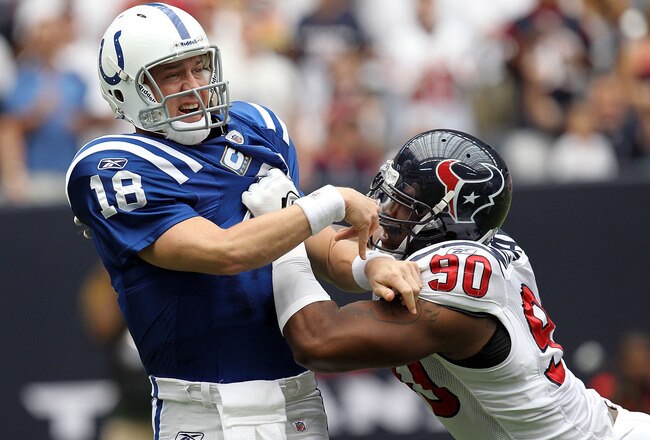 HOUSTON - SEPTEMBER 12:  Quarterback Peyton Manning #18 of the Indianapolis Colts is tackled by Mario Williams #90 of the Houston Texans during the NFL season opener at Reliant Stadium on September 12, 2010 in Houston, Texas.  (Photo by Ronald Martinez/Getty Images)