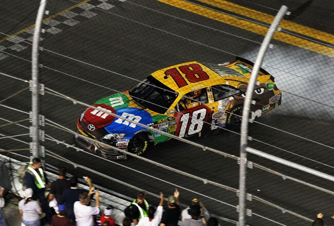 DAYTONA BEACH, FL - FEBRUARY 18:  Kyle Busch, driver of the #18 M&M's Brown Toyota, burns out after winning the NASCAR Budweiser Shootout at Daytona International Speedway on February 18, 2012 in Daytona Beach, Florida.  (Photo by Jamie Squire/Getty Images)