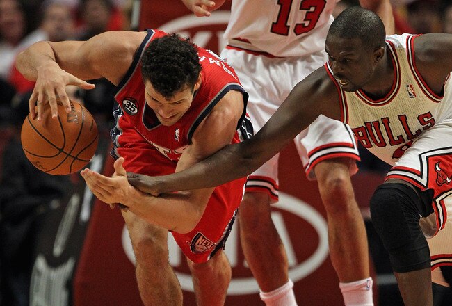 CHICAGO, IL - FEBRUARY 18: Loul Deng #9 of the Chicago Bulls tries to knock the ball away from Kris Humphries #43 of the New Jersey Nets at the United Center on February 18, 2012 in Chicago, Illinois. The Nets defeated the Bulls 97-85. NOTE TO USER: User expressly acknowledges and agrees that, by downloading and or using this photograph, User is consenting to the terms and conditions of the Getty Images License Agreement. (Photo by Jonathan Daniel/Getty Images)