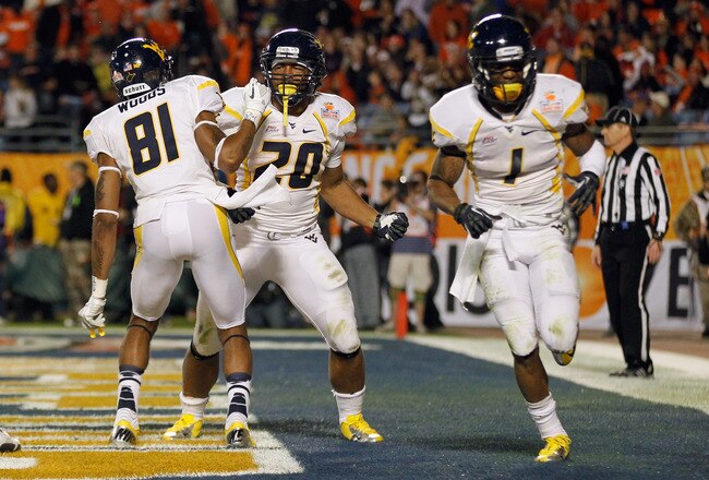 MIAMI GARDENS, FL - JANUARY 04:  (L-R) J.D. Woods #81, Shawne Alston #20 and Tavon Austin #1 of the West Virginia Mountaineers celebrate after Austin scored a touchdown in the second half against the Clemson Tigers during the Discover Orange Bowl at Sun Life Stadium on January 4, 2012 in Miami Gardens, Florida.  (Photo by Streeter Lecka/Getty Images)