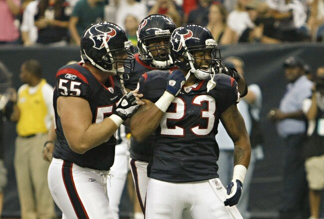 HOUSTON - AUGUST 20:  Running back Arian Foster #23 of the Houston Texans celebrates with center Chris Myers #55 after scoring in the first quarter against the New Orleans Saints at Reliant Stadium on August 20, 2011 in Houston, Texas.  (Photo by Bob Levey/Getty Images)