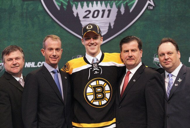 ST PAUL, MN - JUNE 24:  Ninth overall pick Dougie Hamilton by the Boston Bruins satnds on stage with members of the Boston Bruins organization during day one of the 2011 NHL Entry Draft at Xcel Energy Center on June 24, 2011 in St Paul, Minnesota.  (Photo by Bruce Bennett/Getty Images)