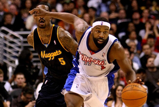 LOS ANGELES - NOVEMBER 20: Baron Davis #1 of the Los Angeles Clippers drives with the ball ahead of J.R. Smith #5 of the Denver Nuggets on November 20, 2009 at Staples Center in Los Angeles, California.  The Clippers won 106-99.    NOTE TO USER: User expressly acknowledges and agrees that, by downloading and/or using this Photograph, user is consenting to the terms and conditions of the Getty Images License Agreement. (Photo by Stephen Dunn/Getty Images)