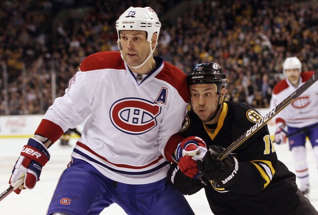 BOSTON, MA - DECEMBER 19: Gregory Campbell #11 of the Boston Bruins skates against Hal Gill #75 of the Montreal Canadiens at the TD Garden on December 19, 2011 in Boston, Massachusetts.  (Photo by Bruce Bennett/Getty Images)