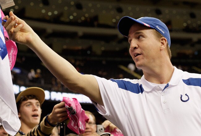 NEW ORLEANS, LA - OCTOBER 23:  Peyton Manning #18 of the Indianapolis Colts signs autographs for fans before the Colts take on the New Orleans Saints  at Mercedes-Benz Superdome on October 23, 2011 in New Orleans, Louisiana.  Manning is sidelined for the season with a neck injury.  (Photo by Jamie Squire/Getty Images)