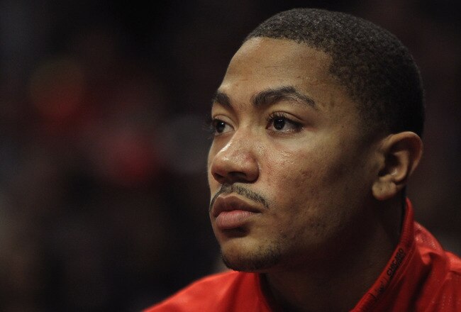 CHICAGO, IL - FEBRUARY 14:  Derrick Rose #1 of the Chicago Bulls, held out of the game with a sore back, watches his teammates take on the Sacramento Kings at the United Center on February 14, 2012 in Chicago, Illinois. The Bulls defeated the Kings 121-115. NOTE TO USER: User expressly acknowledges and agrees that, by downloading and or using this photograph, User is consenting to the terms and conditions of the Getty Images License Agreement.  (Photo by Jonathan Daniel/Getty Images)