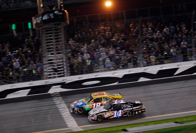 DAYTONA BEACH, FL - FEBRUARY 18:  Kyle Busch, driver of the #18 M&M's Brown Toyota, edges out Tony Stewart, driver of the #14 Office Depot/Mobil 1 Chevrolet, to win the NASCAR Budweiser Shootout at Daytona International Speedway on February 18, 2012 in Daytona Beach, Florida.  (Photo by Chris Graythen/Getty Images)