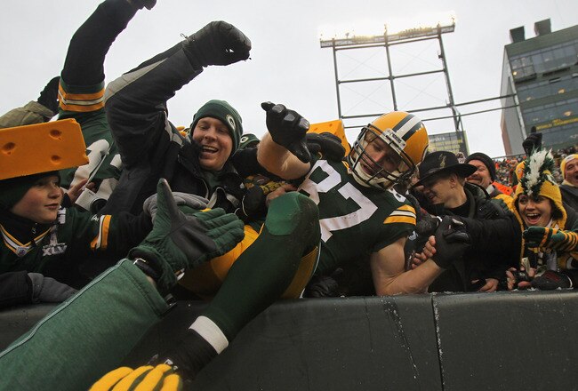 GREEN BAY, WI - JANUARY 01:  Jordy Nelson #87 of the Green Bay Packers leaps into the stands after catching a touchdown pass against the Detroit Lions at Lambeau Field on January 1, 2012 in Green Bay, Wisconsin. The Packers defeated the Lions 45-41.  (Photo by Jonathan Daniel/Getty Images)
